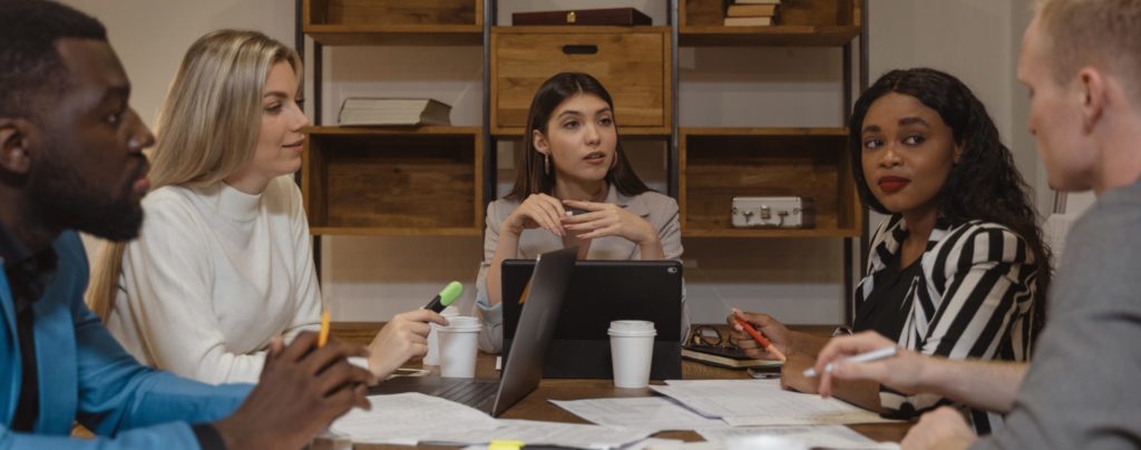 3 women and 2 men having a meeting