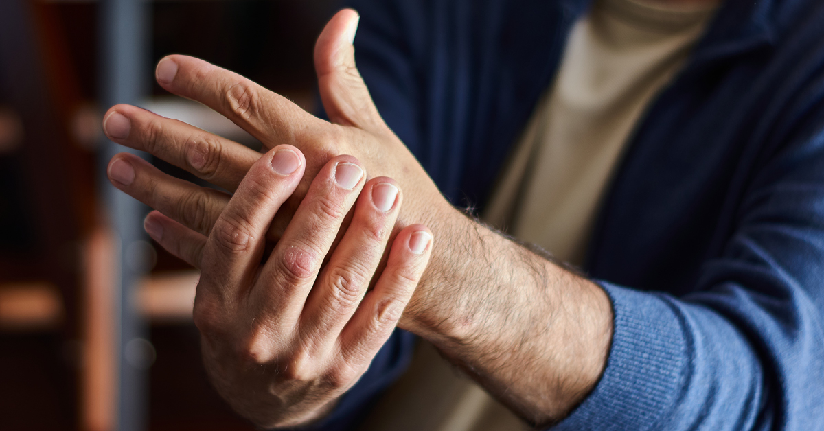 man rubbing hand