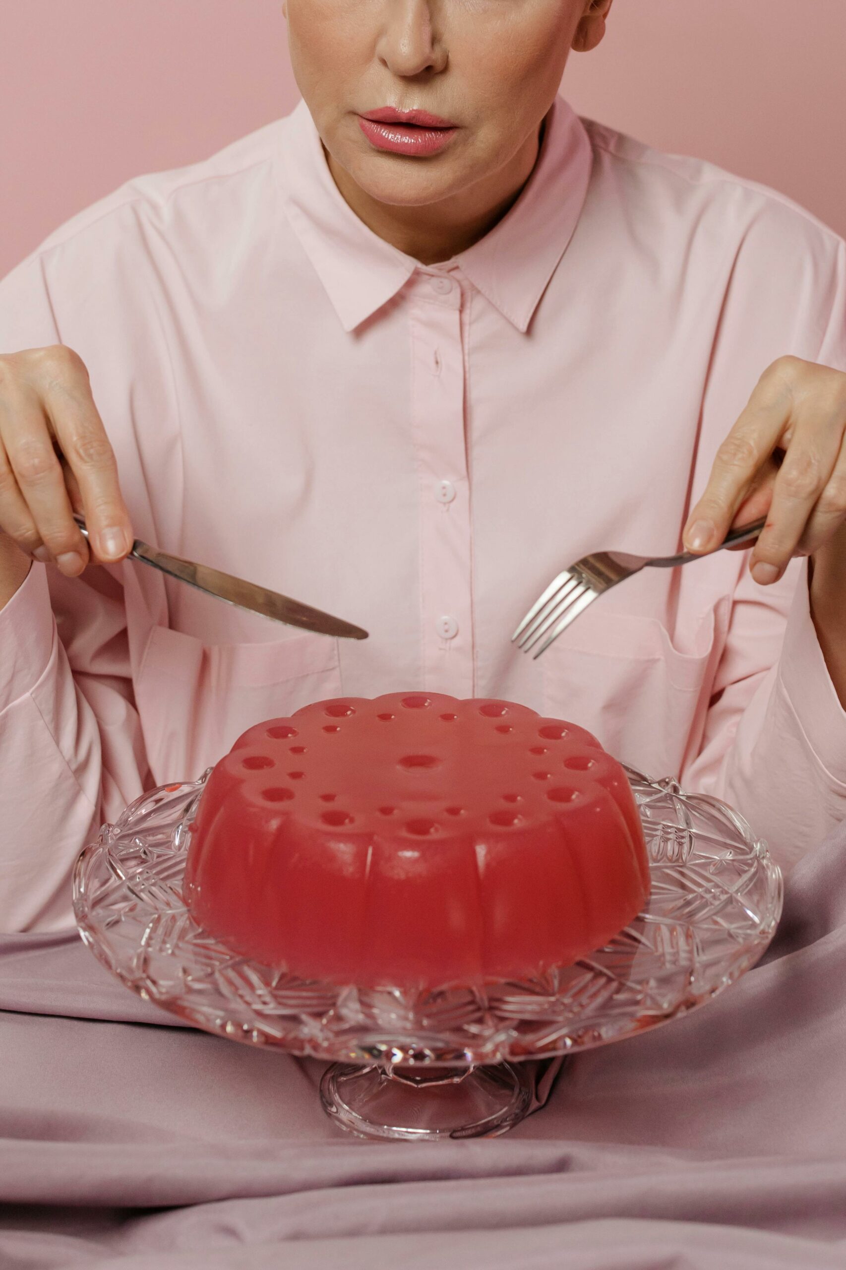 person cutting into jello pie